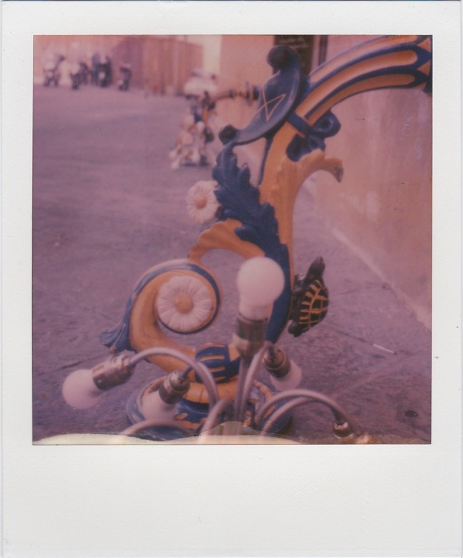 A lamppost decorated in the colours of a contrada.