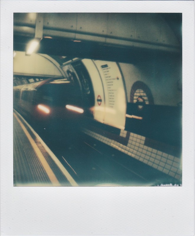 A tube entering a London Underground station.